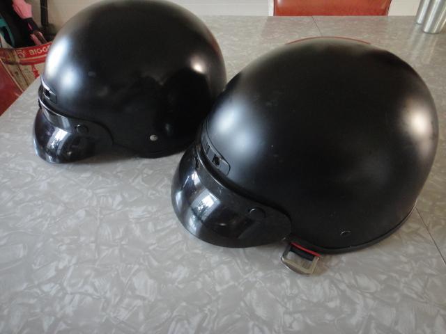 Motorcycle helmets, two included, flat black with visor, size medium, used.