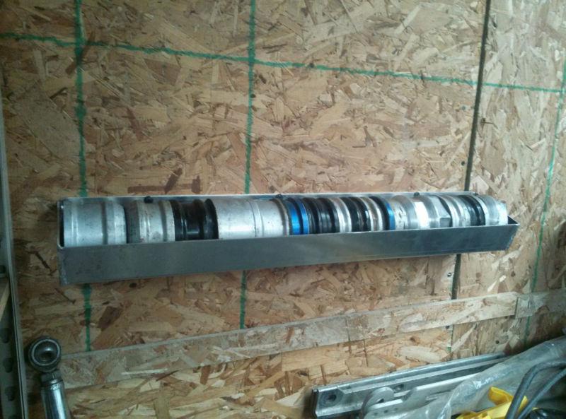 Sprint car wheel spacer tray wall mount