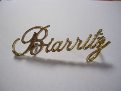 Cadillac biarritz gold script emblem used 2 studs (used) 80's-90's