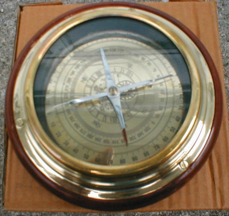 Brass compass mounted on polished wood   $17.95          